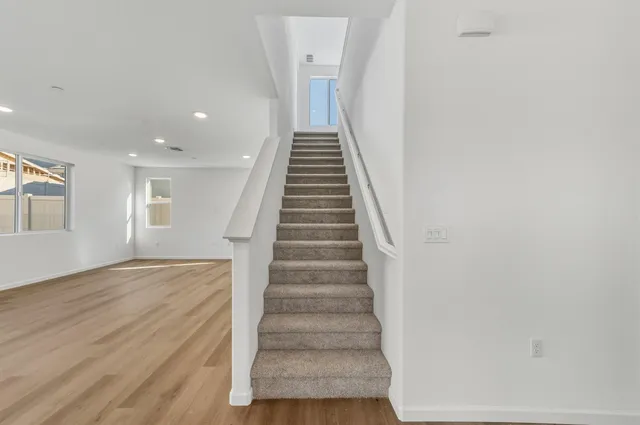 a view of entryway and hall with wooden floor