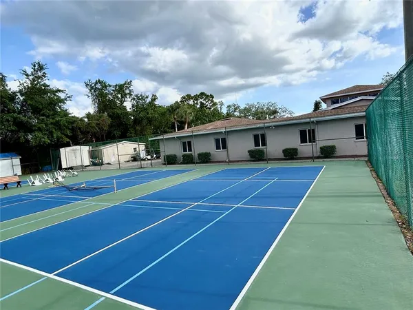 a view of tennis court with houses