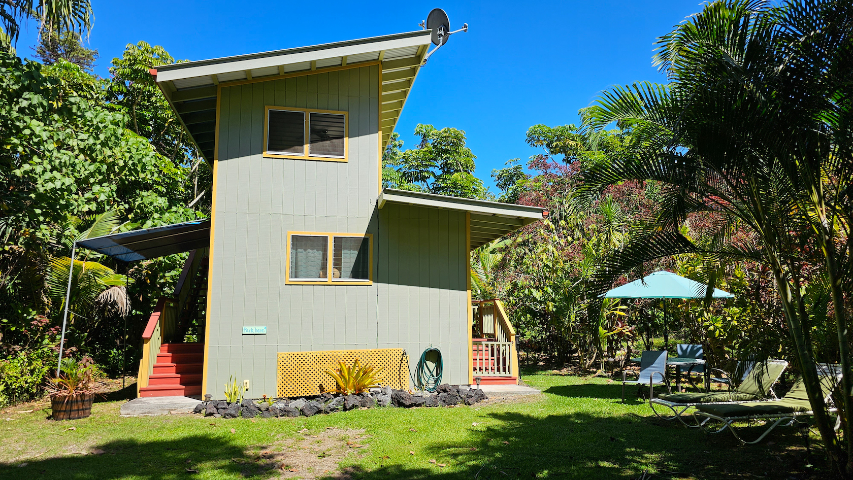 14-249 Pakaka Road Pahoa, HI 96778 - Photo 7 of 29 a view of a white house with a yard and plants