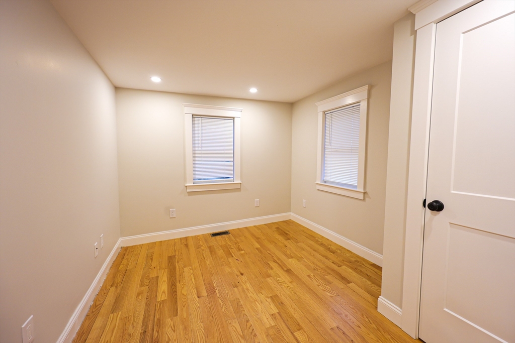 85 Oak Street, Unit 85 Randolph, MA 02368 - Photo 13 of 26 a view of empty room with wooden floor