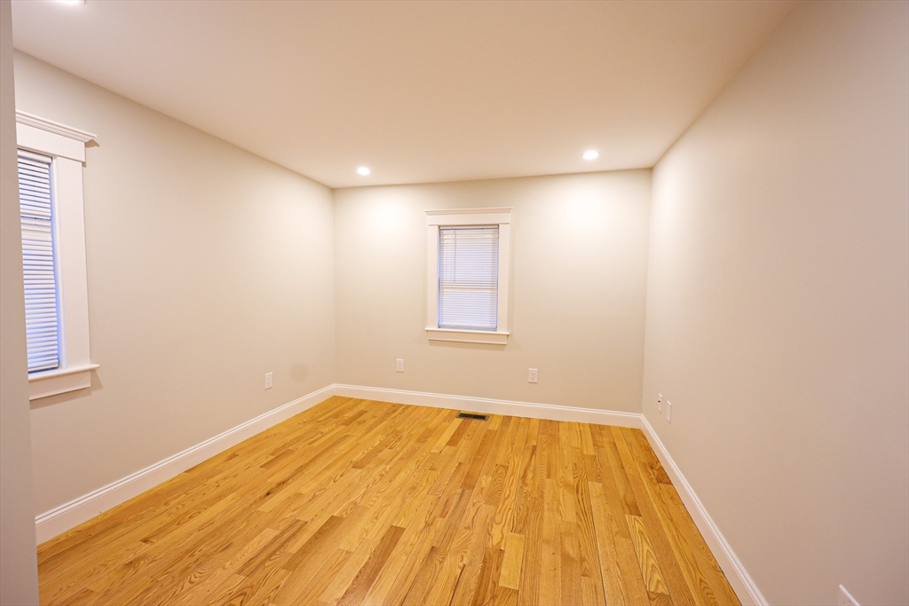 85 Oak Street, Unit 85 Randolph, MA 02368 - Photo 14 of 26 a view of empty room with wooden floor