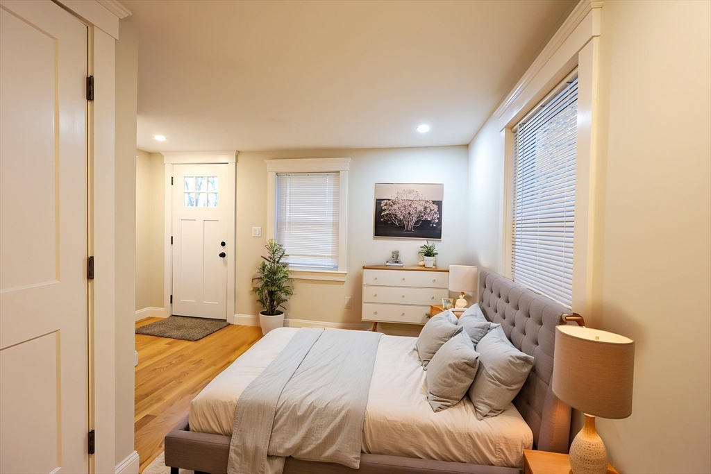85 Oak Street, Unit 85 Randolph, MA 02368 - Photo 2 of 26 a bedroom with a bed and a flat screen tv