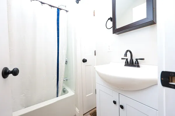 a bathroom with a sink and mirror