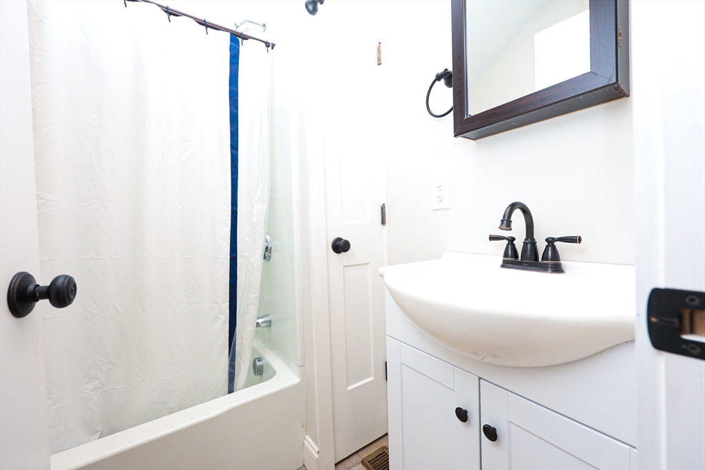 85 Oak Street, Unit 85 Randolph, MA 02368 - Photo 22 of 26 a bathroom with a sink and mirror