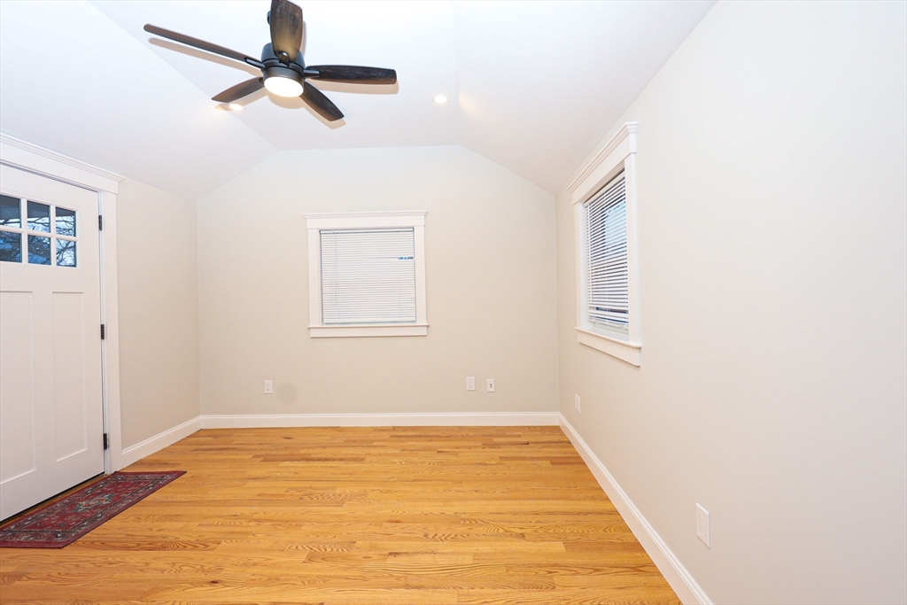 85 Oak Street, Unit 85 Randolph, MA 02368 - Photo 23 of 26 a view of a room with wooden floor and ceiling fan