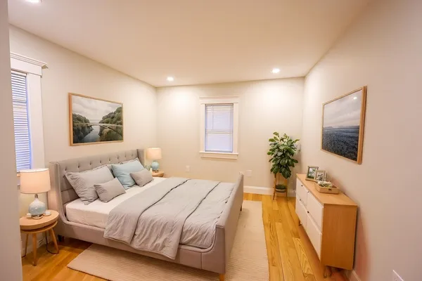 a spacious bedroom with a bed and a flat screen tv
