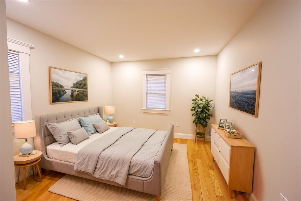 85 Oak Street, Unit 85 Randolph, MA 02368 - Photo 3 of 26 a spacious bedroom with a bed and a flat screen tv