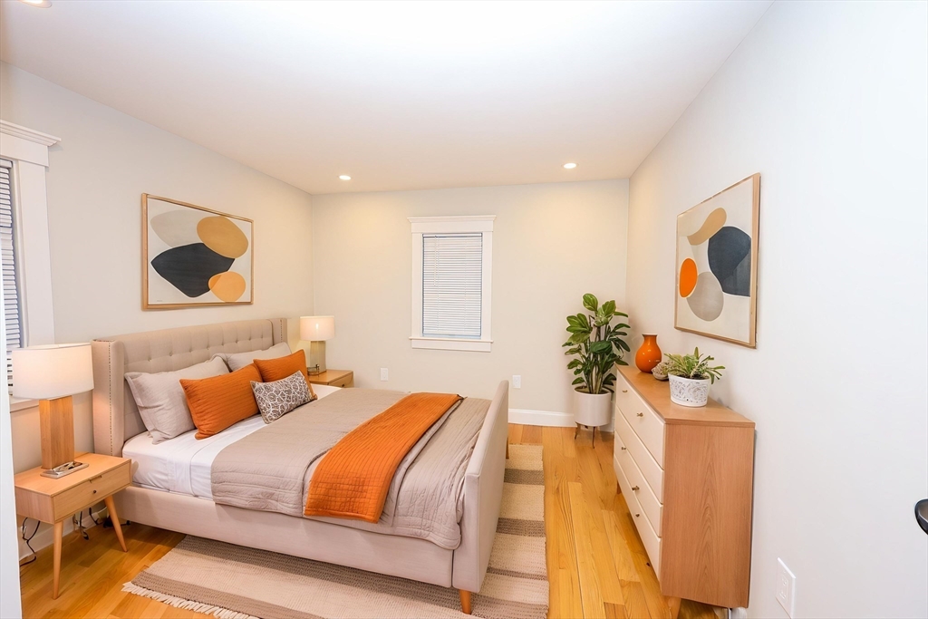 85 Oak Street, Unit 85 Randolph, MA 02368 - Photo 5 of 26 a bedroom with a bed and a painting on the wall