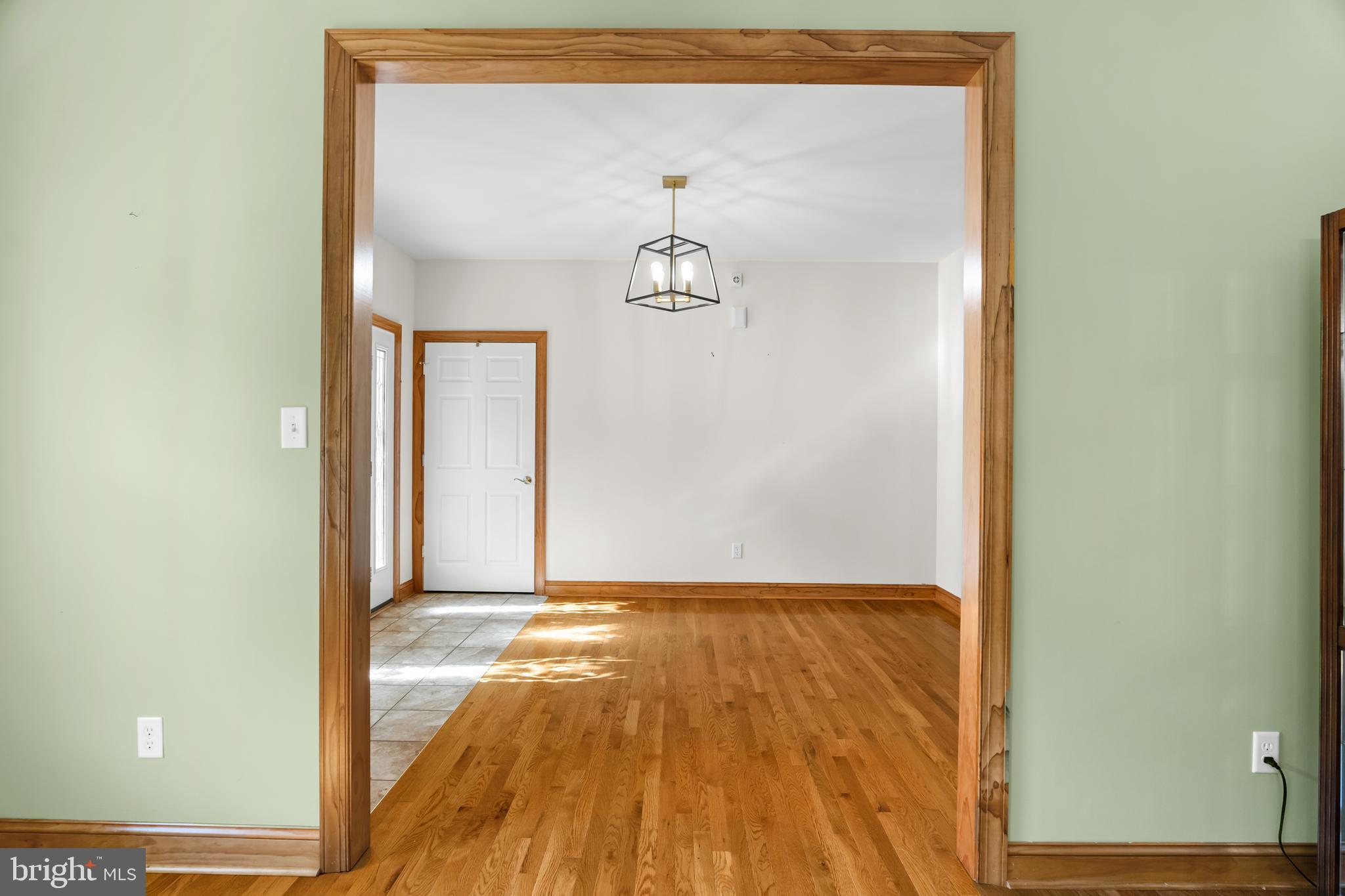 1211 Dexter Corner Road Townsend, DE 19734 - Photo 12 of 66 a view of a hallway with wooden floor and a cabinet