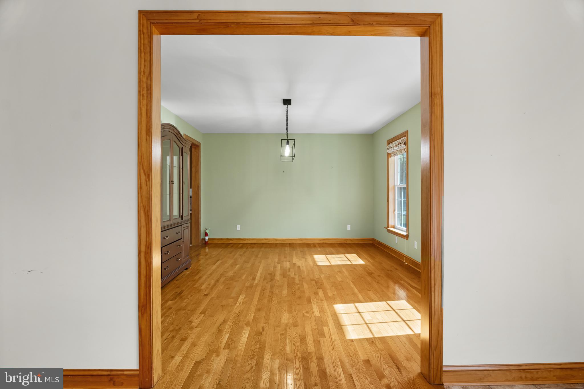 1211 Dexter Corner Road Townsend, DE 19734 - Photo 13 of 66 a view of an empty room with wooden floor and a window