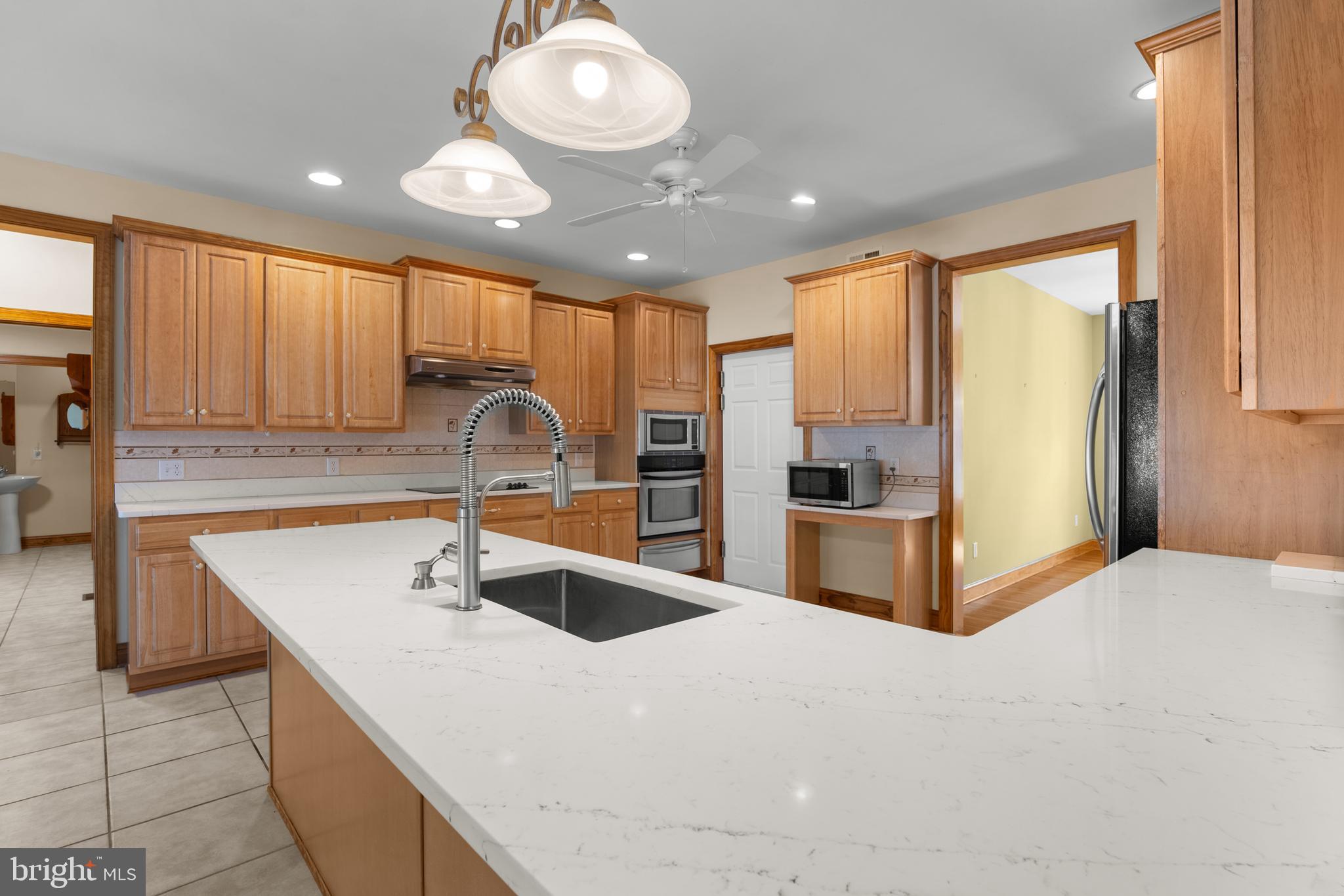 1211 Dexter Corner Road Townsend, DE 19734 - Photo 17 of 66 a kitchen with stainless steel appliances granite countertop a sink a stove and a refrigerator