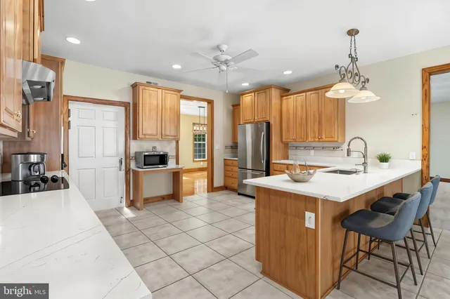 a kitchen with stainless steel appliances granite countertop a sink a stove and a refrigerator