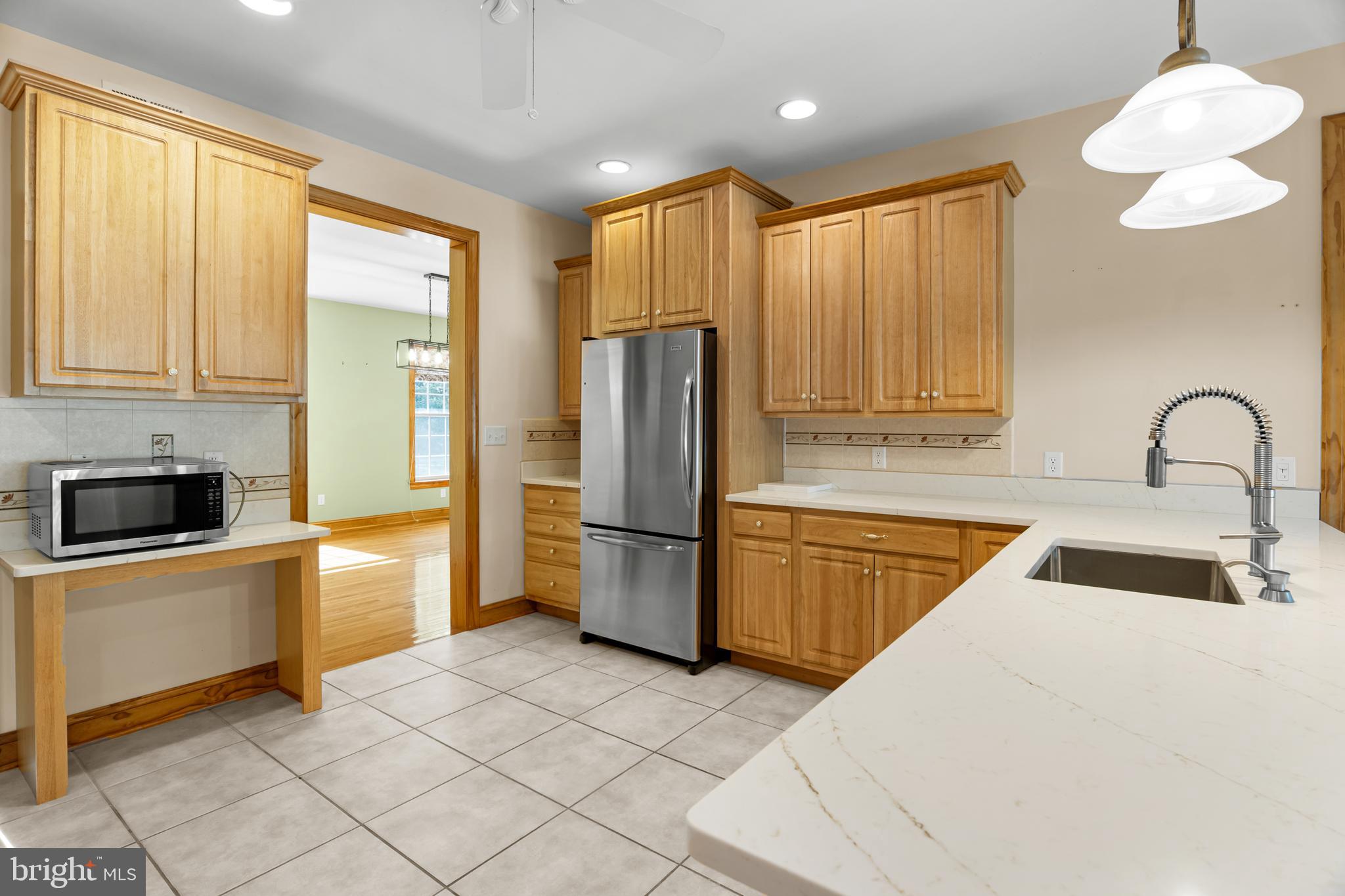 1211 Dexter Corner Road Townsend, DE 19734 - Photo 24 of 66 a kitchen with granite countertop a refrigerator and a sink