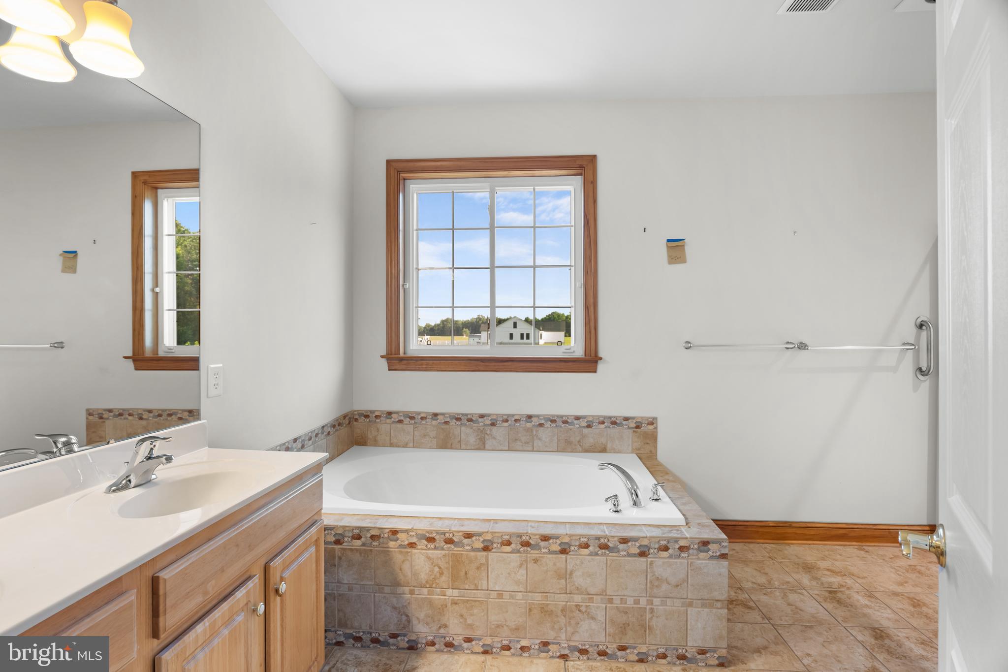 1211 Dexter Corner Road Townsend, DE 19734 - Photo 41 of 66 a bathroom with a granite countertop sink and a bathtub