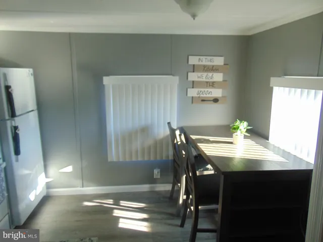 a view of a dining room with furniture and a chandelier