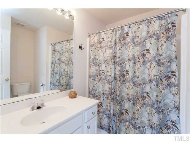 7242 Galon Glen Road Raleigh, NC 27613 - Photo 14 of 17 a bathroom with a sink and a mirror