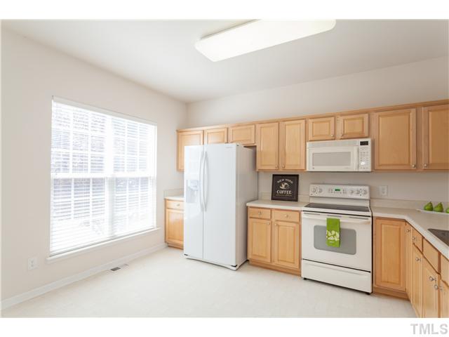 7242 Galon Glen Road Raleigh, NC 27613 - Photo 9 of 17 a kitchen with a stove a refrigerator and a window