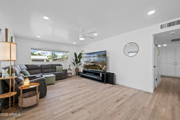 a living room with furniture and a wooden floor