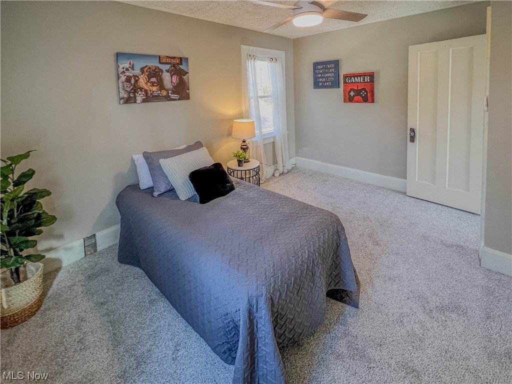 3110 Neosho Road Youngstown, OH 44511 - Photo 19 of 35 Carpeted bedroom featuring ceiling fan and a textured ceiling