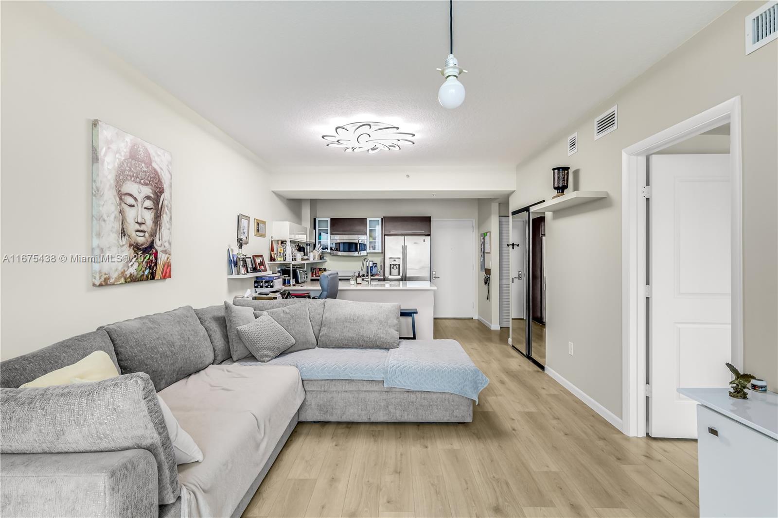 333 Northeast 24th Street, Unit 1206 Miami, FL 33137 - Photo 7 of 26 a living room with furniture and a chandelier