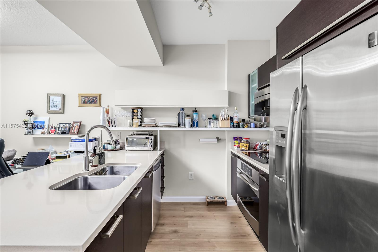 333 Northeast 24th Street, Unit 1206 Miami, FL 33137 - Photo 8 of 26 a kitchen with a sink stove and refrigerator