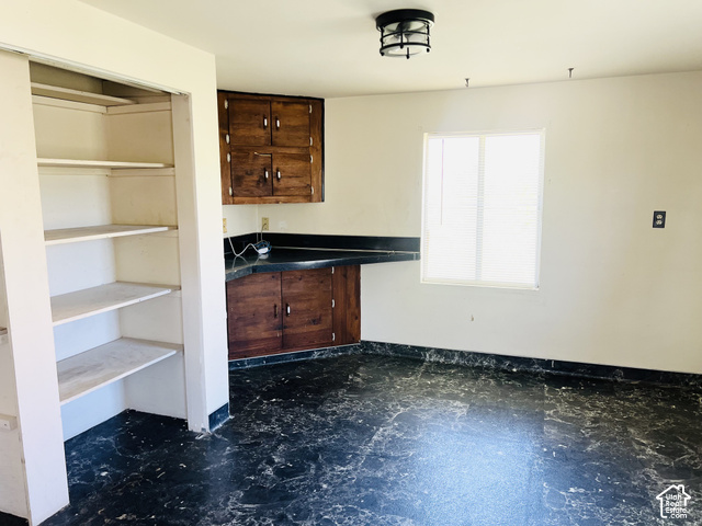 265 Roosevelt Street Helper, UT 84526 - Photo 15 of 27 Large pantry and dining area with desk and cabinets