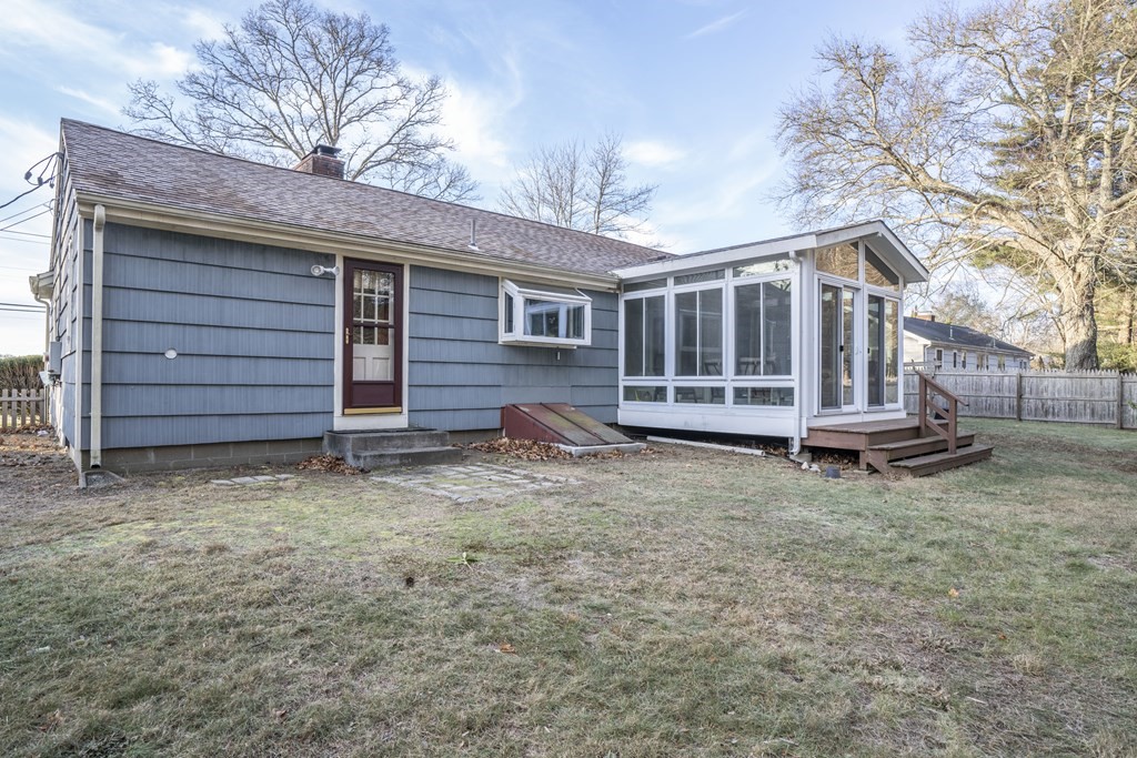 223 Marion Road Rochester, MA 02770 - Photo 5 of 35 a view of a house with a yard and wooden fence