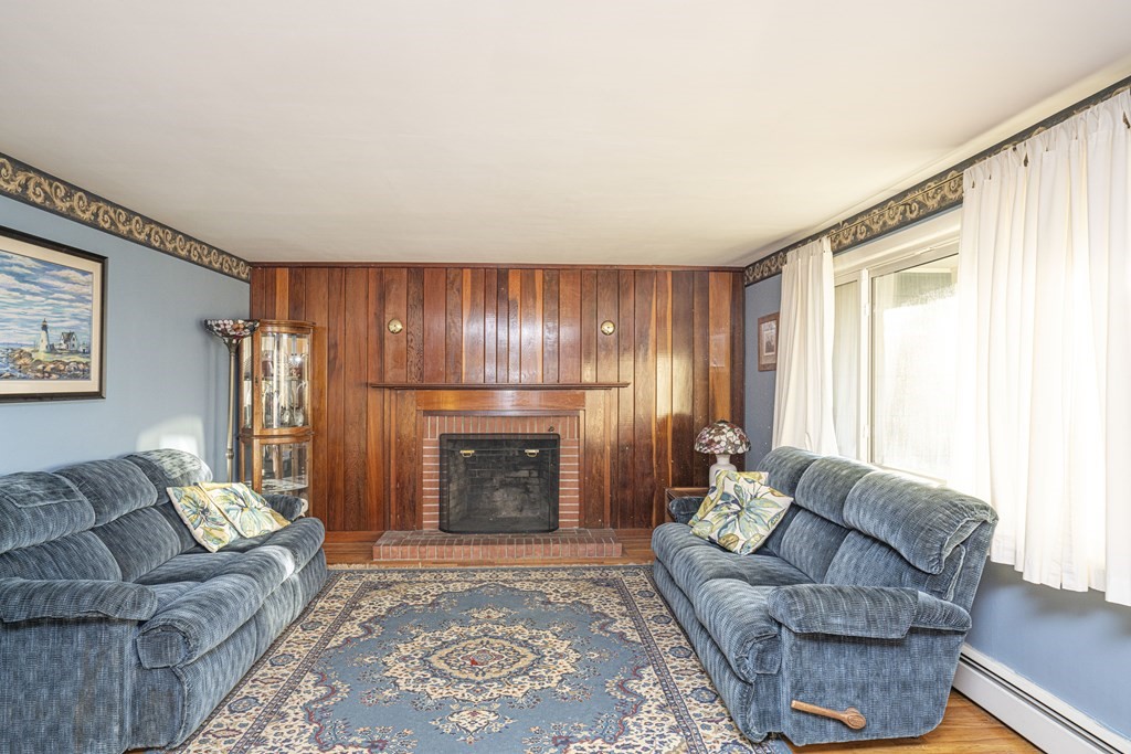 223 Marion Road Rochester, MA 02770 - Photo 8 of 35 a living room with furniture and a fireplace