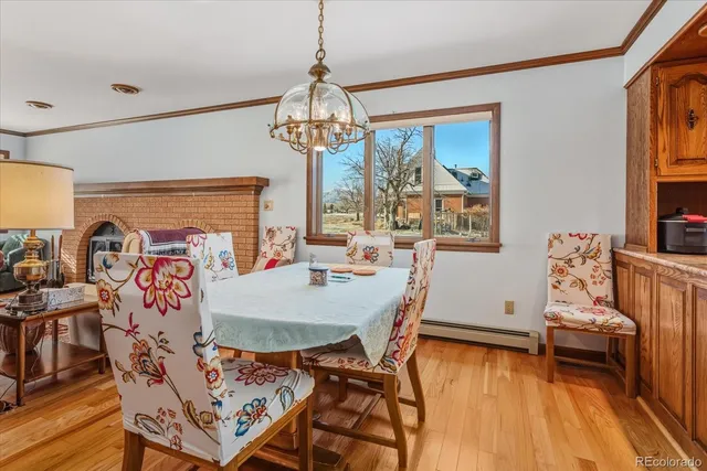 a view of a dining room with furniture wooden floor and chandelier