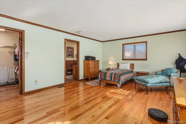 a bedroom with furniture and a wooden floor
