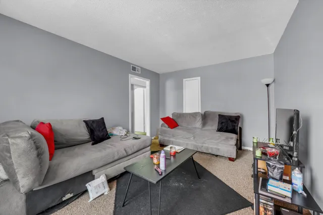 a kitchen with granite countertop cabinets stainless steel appliances and a refrigerator