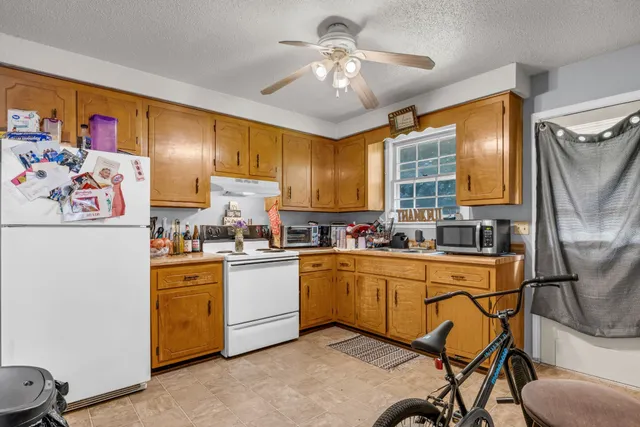 a bathroom with a sink toilet and shower curtain