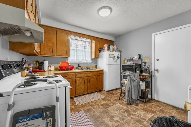 a kitchen with stainless steel appliances granite countertop a refrigerator sink and cabinets