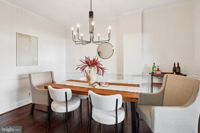 a dining room with furniture and wooden floor