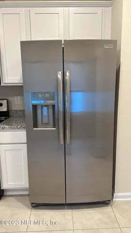 a kitchen with a refrigerator and cabinets