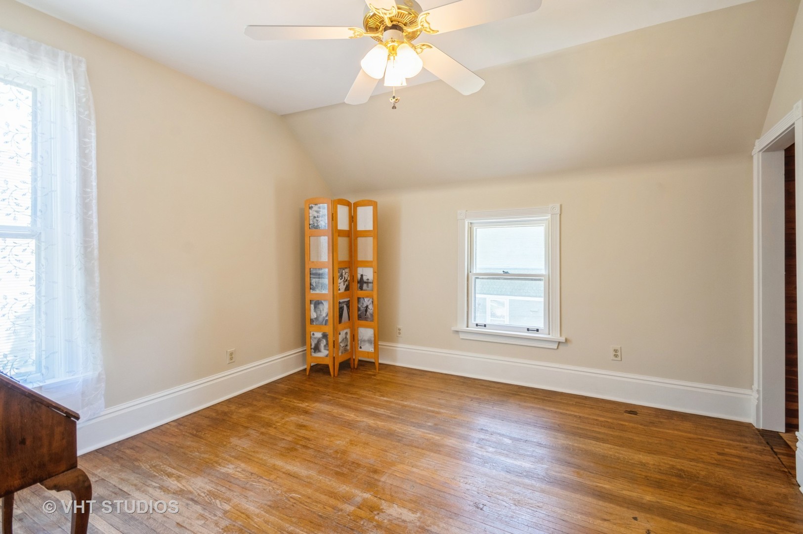 128 Forest Avenue Riverside, IL 60546 - Photo 9 of 18 an empty room with wooden floor fan and windows
