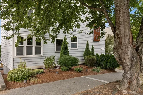 a front view of a house with a yard and tree s