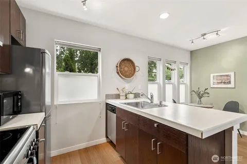 a kitchen with a sink a stove and cabinets