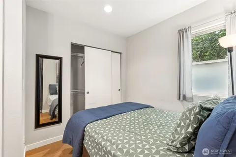 a bedroom with a bed and a window