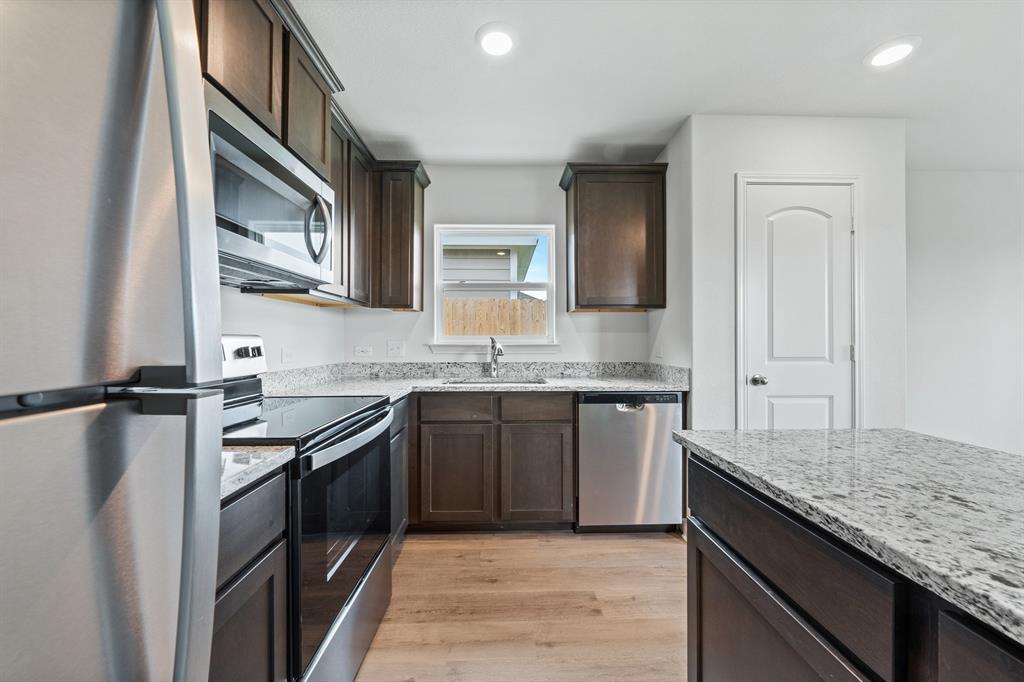 10009 Pilot Place Fort Worth, TX 76131 - Photo 2 of 11 a kitchen with a sink stove and refrigerator
