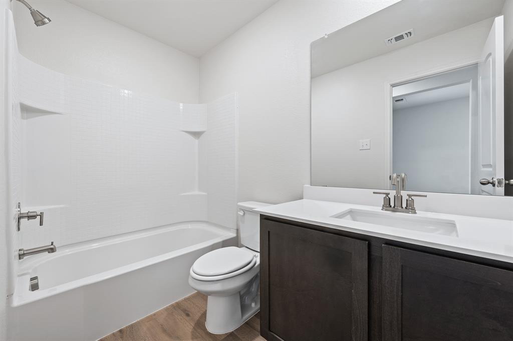 10009 Pilot Place Fort Worth, TX 76131 - Photo 10 of 11 a bathroom with a sink a toilet and shower