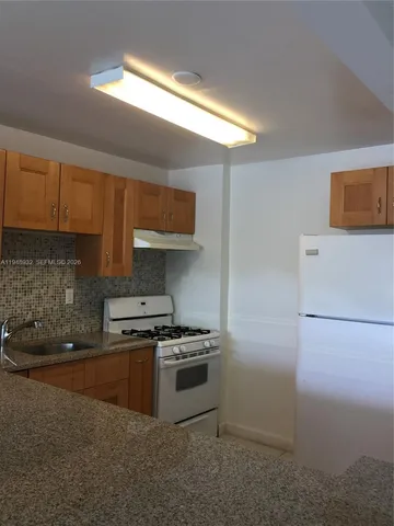 a kitchen with stainless steel appliances a stove a microwave and a refrigerator