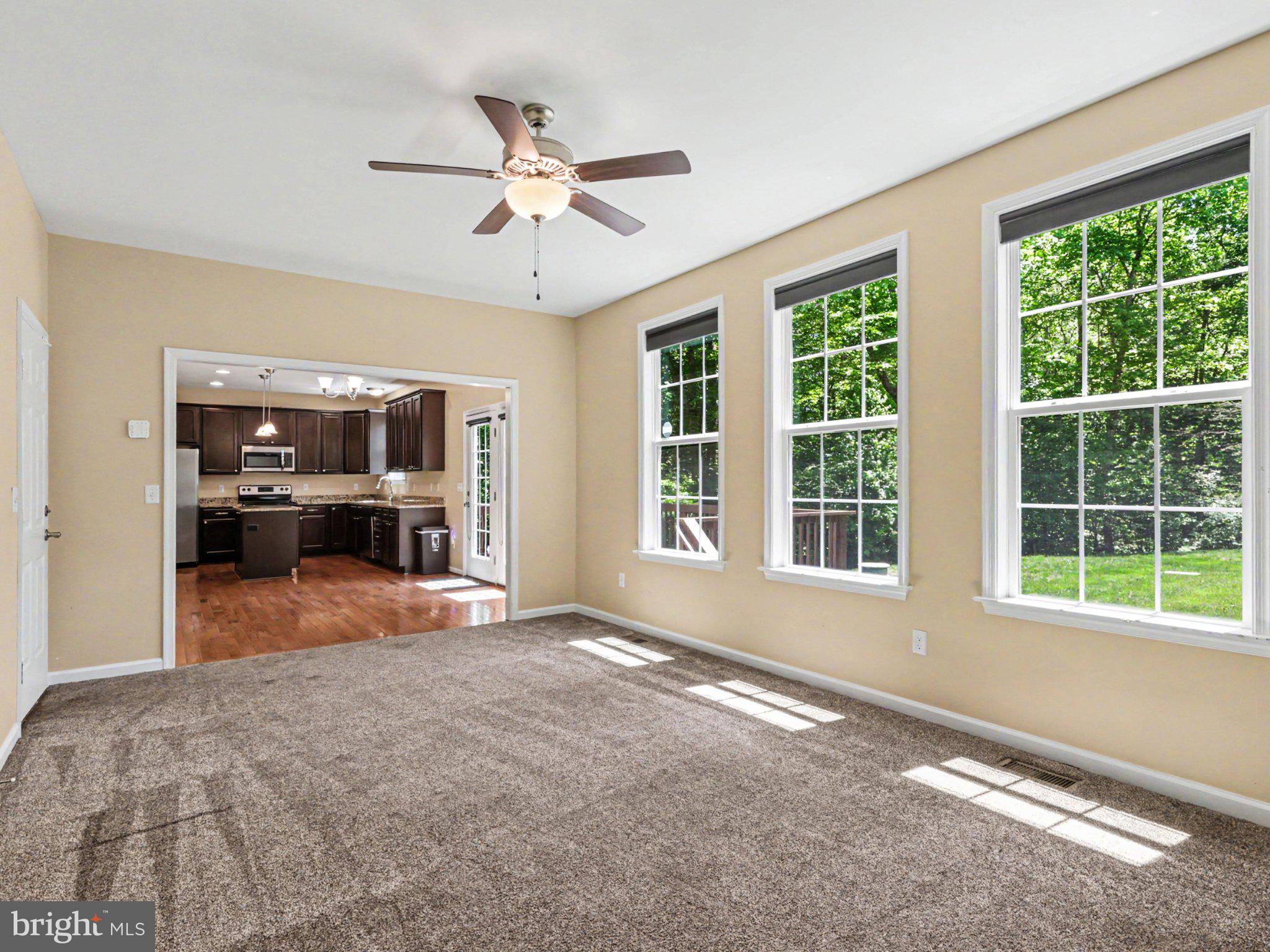 9811 Catharpin Road Spotsylvania, VA 22551 - Photo 6 of 30 a view of an empty room with a window and kitchen area