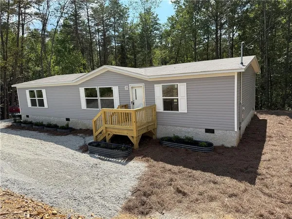 a view of a house with a yard in the background