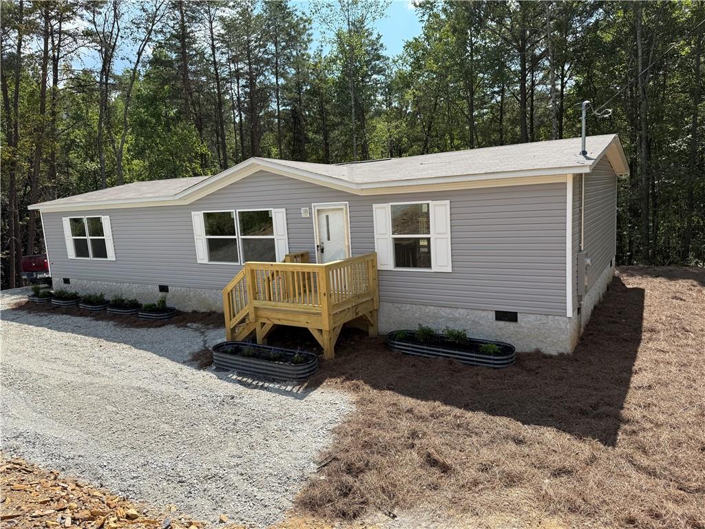 a view of a house with a yard in the background