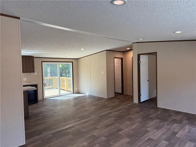 a view of an empty room with closet and a window