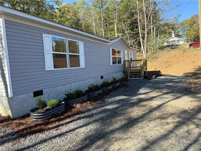a view of a house with a backyard