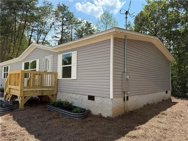 a view of a house with a yard chairs and a yard