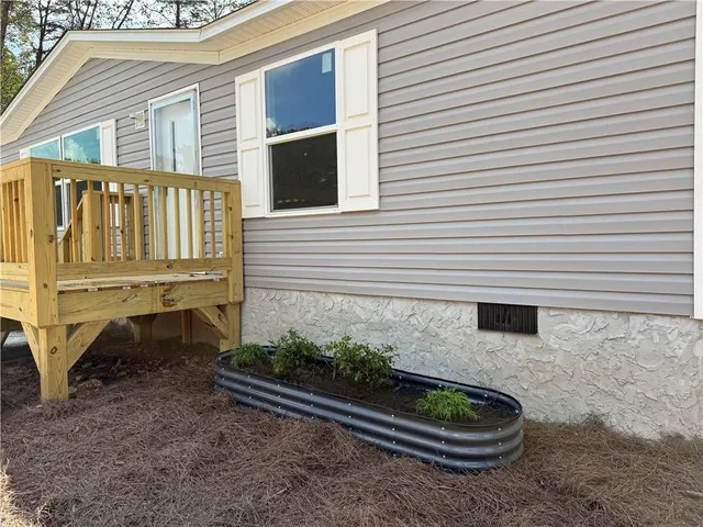 a white bench sitting in front of a house