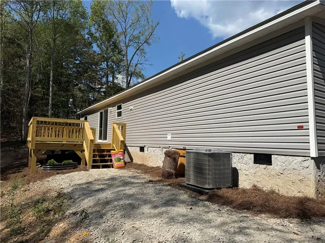 a view of a house with a yard and sitting area